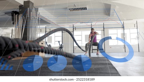 Fitness data analysis image over woman exercising with battle ropes in gym. exercise, workout, technology, digital, athlete, strength - Powered by Shutterstock