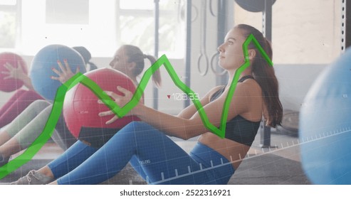 Fitness data graph image over women exercising with medicine balls in gym. exercise, training, workout, health, strength, technology - Powered by Shutterstock