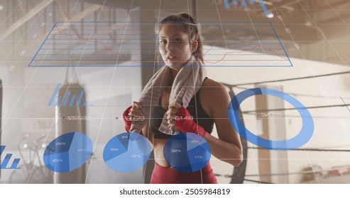 Fitness data visualization image over woman in gym with towel and boxing gloves. exercise, workout, technology, health, training, sports - Powered by Shutterstock