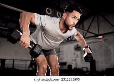 Fitness, dumbbells and man exercise at gym for training workout with focus. Serious male athlete or bodybuilder with weights for strong muscle, power or motivation for hard work and bent over row - Powered by Shutterstock