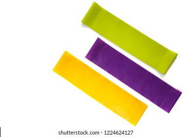 Fitness Elastic Band, Elastic Extenders Of Different Colors For Sports, Isolated On A White Background. Fitness Trend