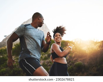 Fitness, energy and athletes running in nature by a mountain training for race, marathon or competition. Sports, health and African couple doing outdoor cardio workout or exercise together at sunset. - Powered by Shutterstock