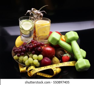 Fitness Equipment And Healthy Food And Detox Water (green Apple, Pepper, Grapes, Nectarines, Kiwi, Orange, Dumbbells And Measuring Tape) 