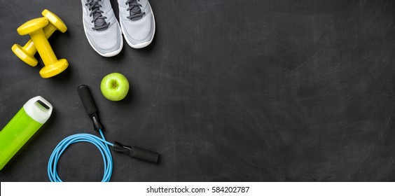 Fitness equipment on a dark background with copy space - Shutterstock ID 584202787