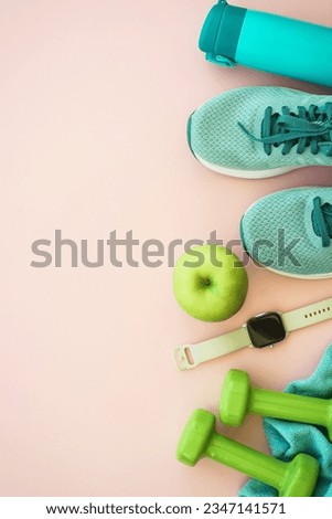 Fitness equipment on pink background, flat lay image.