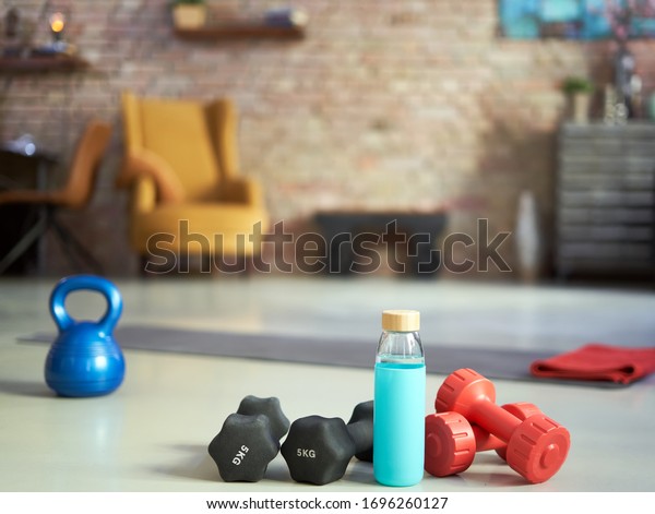 Fitness equipments at home. Focus on fitness
tools, barbell and kettlebell. Concepts about home workout,
fitness, sport and
health.
