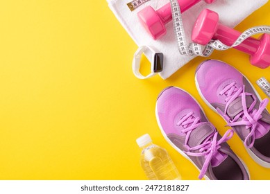 Fitness essentials. Top view photo of female sneakers, towel, dumbbells, measuring tape, fitness tracker, and water bottle on a yellow background with empty space for text or advert - Powered by Shutterstock