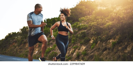 Fitness, exercise and couple running in nature by a mountain training for a race, marathon or competition. Sports, health and athletes or runners doing an outdoor cardio workout together at sunset. - Powered by Shutterstock