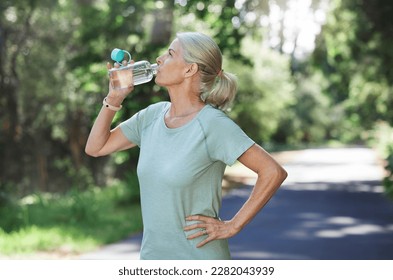 Fitness, exercise and mature woman drinking water, outdoor and training for balance, fresh air and break. Senior female, nature and lady with aqua, retirement and thirsty after practice and workout