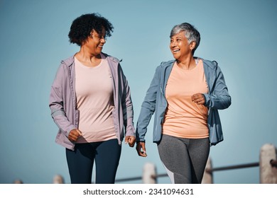 Fitness, exercise and senior women by ocean for healthy lifestyle, wellness and cardio on promenade. Sports, friends and female people in conversation on boardwalk for walking, training and workout - Powered by Shutterstock