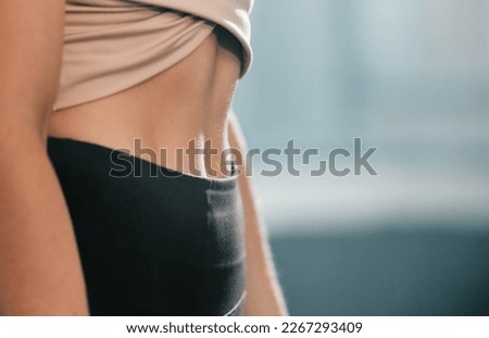 Fitness, exercise and woman with flat stomach at gym for training workout for healthy weight management. Sports, abs and tummy tuck, sporty girl with slim waist and fit belly on diet for body care.
