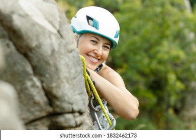 Fitness, Extreme Sport And Healthy Lifestyle Concept - Portrait Of Woman Wtite Safety Helmet. Smiling Girl Spends Time Outdoors. Protective Equipment For Climbing, Cycling And Other Extreme Sports.