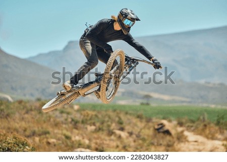 Fitness, extreme sports and mountain bike with man in nature for cycling, jump and adventure. Adrenaline junkie, performance and stunt with athlete riding in outdoors for action, risk and training