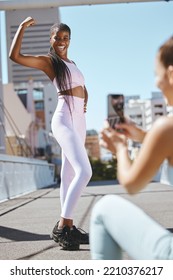 Fitness, Friends And Social Media Influencer Taking Picture Of Strong Power Pose For Health Vlog In A City. Wellness, Training And Blog Advertising By Black Woman And Photographer During Exercise