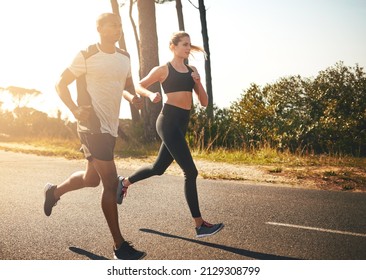 In the fitness game for the long run. Shot of a fit young couple going for a run outdoors. - Powered by Shutterstock