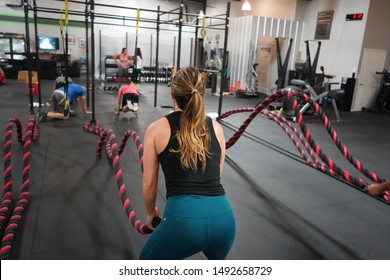 Fitness Girl Doing Battle Ropes In A Bootcamp Class