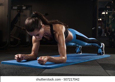 Fitness Girl Exercising With Barbell In Gym