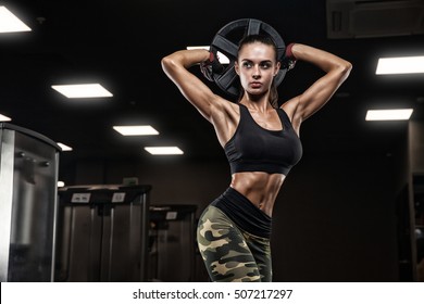 Fitness Girl Exercising With Barbell In Gym