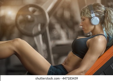 Fitness Girl With Headphones Listening  Music In The Gym 