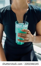 Fitness Girl Holding A Glass With Sports Nutrition Drink