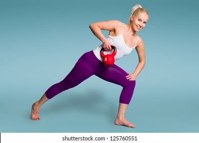 Fitness Girl In One Arm Row Position With A Kettlebell