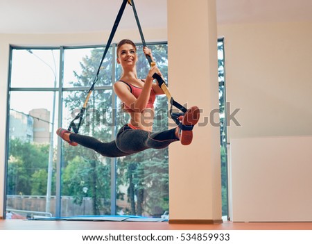 fitness girl split on strap
