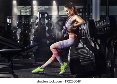 Fitness Girl With Towel And Shaker Relaxing In The Gym