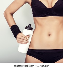 Fitness girl with water close up