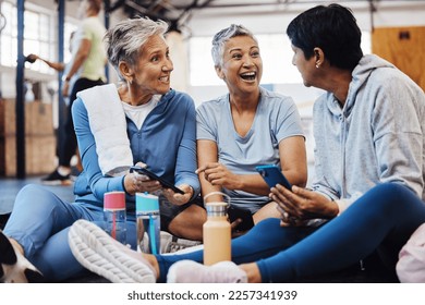 Fitness, gossip and senior friends with phone laughing at meme after yoga class, conversation and comedy on floor. Exercise, bonding and happy mature women checking social media together at workout. - Powered by Shutterstock