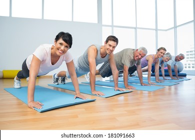 Fitness Group Doing Push Ups In Row At The Yoga Class