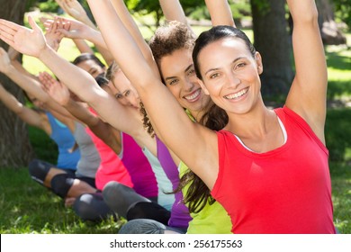 Fitness Group Doing Yoga In Park On A Sunny Day