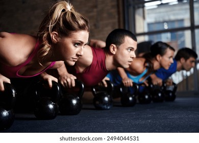 Fitness group, gym and push up with kettlebell for exercise, balance or coordination and strength building. Weights, physical cardio and stability for core, muscles and training for workout. - Powered by Shutterstock