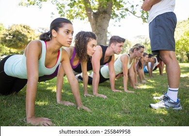 Fitness group planking in park on a sunny day - Powered by Shutterstock