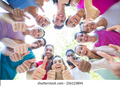 Fitness Group Smiling At Camera In Park On A Sunny Day