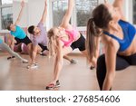 Fitness group stretching body during fitness classes