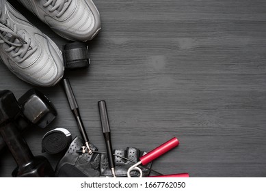 Fitness Gym Equipment On Black Wooden Background With Copy Space.