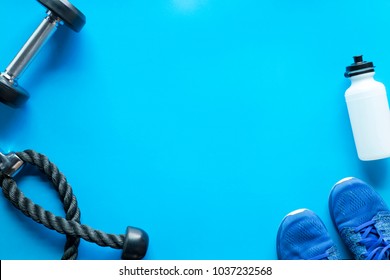 Fitness Gym equipment on blue background with free copy space