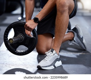 Fitness, gym or hands training with a barbell or heavy equipment for muscle growth or development workout. Shoes, bodybuilder or healthy strong man starting weightlifting strength training exercise