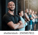 Fitness, gym and man in row for portrait, confidence and ready for workout in class. Arms crossed, personal trainer and smile in training center for exercise, wellness and determination for growth