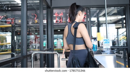 Fitness Gym Reopening, Woman In Sportswear Washing Hands With Sanitizer Disinfecting While Being In A Lobby At Health Club. Before Work Out In A Gym During Coronavirus Epidemic, Healthy Lifestyle.