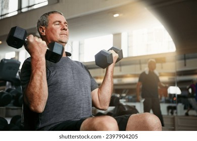 Fitness, gym and senior man with dumbbells for weightlifting, challenge or cardio workout, training or bodybuilding. Biceps, arms and elderly person with hand weight for strength, mindset or exercise - Powered by Shutterstock