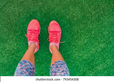 Fitness And Health Concept. Top View Of Running Shoes Woman Standing On Grass Pov Selfie Of Feet During Exercise Run Workout Outdoors. Sport And Active Lifestyle.