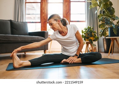 Fitness, Health And Pilates By Elderly Woman Exercise And Stretching On Floor, Wellness And Relax In Living Room. Zen, Yoga And Meditation By Senior Female Workout In Home, Healthy Cardio Practice