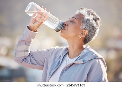 Fitness, health and senior woman drinking water for hydration on outdoor cardio run, exercise or retirement workout. Marathon training, bottle and profile of runner running in Rio de Janeiro Brazil - Powered by Shutterstock