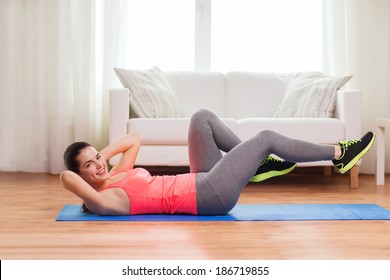 Fitness, Home And Diet Concept - Smiling Teenage Girl Doing Exercise On Floor At Home