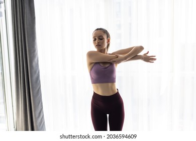 Fitness, Home And Diet Concept - Smiling Young Woman Streching Hands At Home