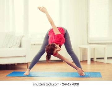 Fitness, Home And Diet Concept - Smiling Teenage Girl Streching At Home