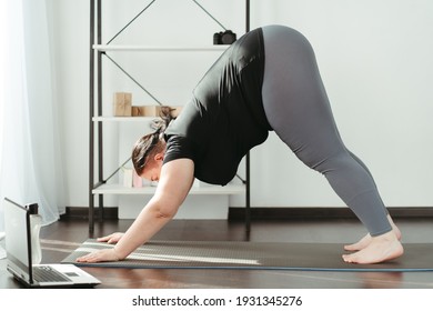 Fitness, Home Training, Online Yoga Class. Overweight Woman Practicing Yoga At Home. Stretching Exercise For Cool Down And Relax