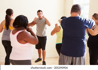 Fitness Instructor In Exercise Class For Overweight People