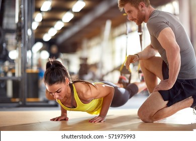 Fitness instructor with girl on training in fitness center